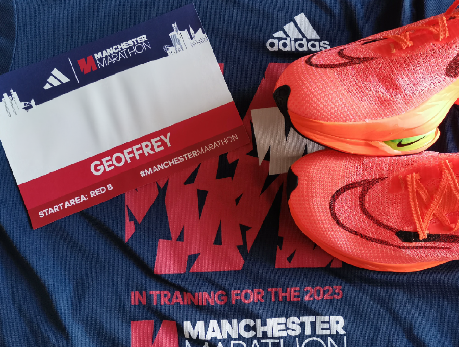 My Manchester Marathon race number (with the actual number hidden) and racing shoes. 